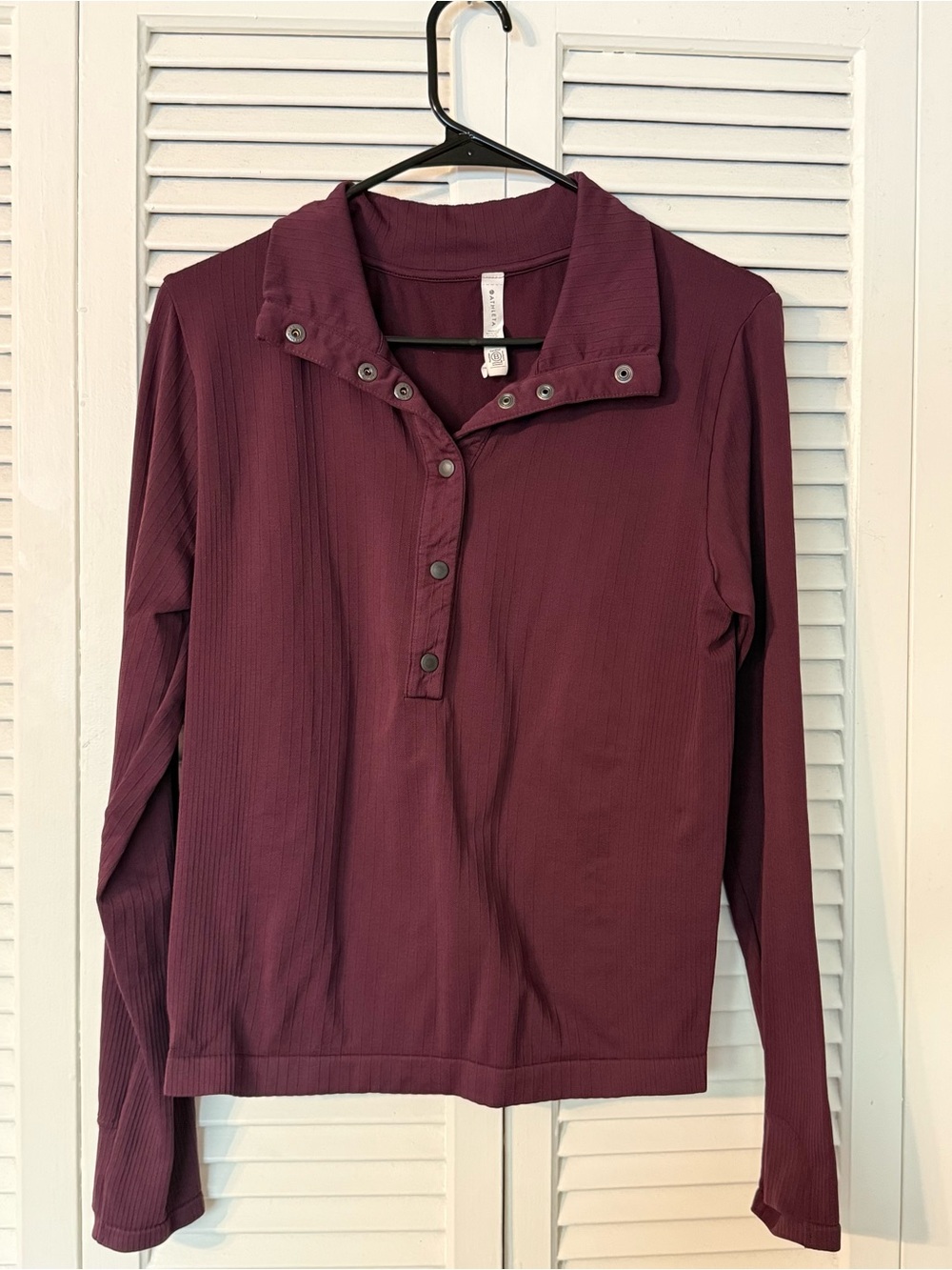 Athleta burgundy long sleeve collared top with thumb holes. Size L